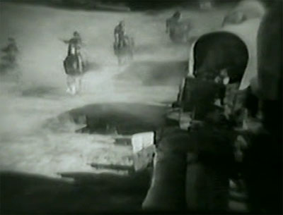 Indians Are Coming--wagon train attack